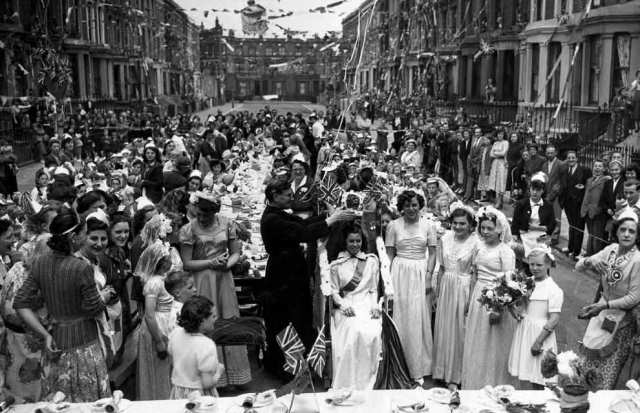 Up and down the land, her subjects celebrated at street parties complete with their own queen. At this one in Kensington, London, 14-year-old Maureen Atkins was 'crowned'  by the local vicar. Some 253 children attended enjoying a magic show, clowns and cake. They were later given a 15 shilling savings certificate.